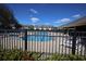 A gated community pool surrounded by lounge chairs and townhomes offering a recreational outdoor space at 8010 Bally Money Rd, Tampa, FL 33610