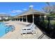 A community pool with lounge chairs and a pool house offering a recreational outdoor space in a community setting at 8010 Bally Money Rd, Tampa, FL 33610