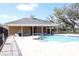 Community pool with a spacious deck, pool house, and lounge chairs for relaxation on a sunny day at 8010 Bally Money Rd, Tampa, FL 33610