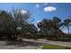 Gated community entrance with stone pillars and mature trees at 8010 Bally Money Rd, Tampa, FL 33610