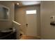 Foyer with light walls, tile flooring, a coat rack, and a staircase leading to the upper level at 8010 Bally Money Rd, Tampa, FL 33610