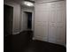 Hallway with wood-look flooring featuring a large closet and access to other rooms in the home at 8010 Bally Money Rd, Tampa, FL 33610