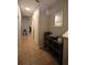 Neutral hallway with tile flooring showcasing a console table and decor for added style and functionality at 8010 Bally Money Rd, Tampa, FL 33610