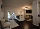 Spacious living room with a television, comfortable seating, and sliding door access to the outside at 8010 Bally Money Rd, Tampa, FL 33610