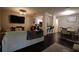 Open living area with a living room, bar seating, and dining area, creating a welcoming atmosphere at 8010 Bally Money Rd, Tampa, FL 33610
