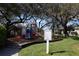 Community playground with slides, climbing structures, and mature shade trees for safe outdoor fun at 8010 Bally Money Rd, Tampa, FL 33610