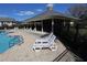 Relaxing poolside with lounge chairs and covered seating on a sunny day at 8010 Bally Money Rd, Tampa, FL 33610