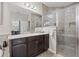 Bathroom with a granite countertop, dark wood cabinets, and a glass-enclosed tiled shower at 8106 Pine Crest St, Seminole, FL 33777