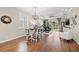 Living room open to dining area with hardwood floors, fan, sliding door access, and comfortable furniture at 8106 Pine Crest St, Seminole, FL 33777