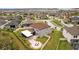 Aerial view of a backyard featuring a covered patio, outdoor dining set, and well-maintained lawn at 8161 Lago Mist Way, Wesley Chapel, FL 33545