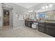 An elegant main bathroom with dual sinks, granite countertops, and walk-in closet at 8161 Lago Mist Way, Wesley Chapel, FL 33545