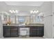 Elegant bathroom featuring dual vanity with granite countertop and ample lighting at 8161 Lago Mist Way, Wesley Chapel, FL 33545