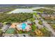 Aerial view of the community pool and amenities, with nearby lakes and lush greenery at 9033 Aspen Hollow Pl, Riverview, FL 33578