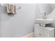 This bathroom features a modern white vessel sink, vanity with storage, and a decorative oval mirror at 9033 Aspen Hollow Pl, Riverview, FL 33578