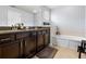 Bathroom features double vanity, granite countertops, and a soaking tub at 9033 Aspen Hollow Pl, Riverview, FL 33578