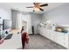 Bedroom featuring a desk, office chair, and decorative white storage system at 9033 Aspen Hollow Pl, Riverview, FL 33578