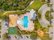 Aerial view of a resort style community pool with a playground and basketball court at 9033 Aspen Hollow Pl, Riverview, FL 33578