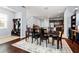 Open-concept dining room with elegant hardwood floors and a stylish area rug at 9033 Aspen Hollow Pl, Riverview, FL 33578