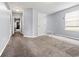 Spacious hallway with carpet floors and neutral walls, leading to various rooms at 9033 Aspen Hollow Pl, Riverview, FL 33578