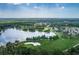 Aerial view of the community golf course, surrounded by lush greenery and a lake at 9408 Greenpointe Dr, Tampa, FL 33626