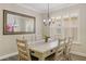 Elegant dining room featuring a large table, stylish lighting, and window shutters at 9408 Greenpointe Dr, Tampa, FL 33626