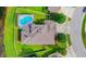 An aerial top-down view shows a house with a private pool, roof detail, green lawn, and driveway at 9729 Asbel Estates St, Land O Lakes, FL 34638