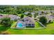 A beautiful backyard featuring a screened-in pool and well-manicured lawn with partial lake views at 9729 Asbel Estates St, Land O Lakes, FL 34638