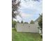 Fenced backyard with lush greenery, a well-maintained fence, and a view of the surrounding landscape at 9729 Asbel Estates St, Land O Lakes, FL 34638