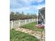 Landscaped backyard featuring stone pathway, lawn, fence, and view of a tranquil lake at 9729 Asbel Estates St, Land O Lakes, FL 34638