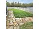 Beautiful flagstone patio leading to a well-maintained lawn, and a fenced yard overlooking a serene lake at 9729 Asbel Estates St, Land O Lakes, FL 34638