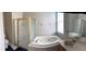 This bathroom includes a large soaking tub, glass-enclosed shower, and spacious vanity at 9729 Asbel Estates St, Land O Lakes, FL 34638
