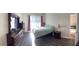 Spacious bedroom with wood floors and an ample dresser at 9729 Asbel Estates St, Land O Lakes, FL 34638