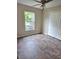 A carpeted bedroom with a ceiling fan and a window with lots of natural light at 9729 Asbel Estates St, Land O Lakes, FL 34638