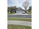 Charming home with a three car garage, lush landscaping, and a welcoming front porch at 9729 Asbel Estates St, Land O Lakes, FL 34638