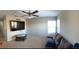 Spacious living room with plush carpeting, ceiling fan and large screen TV for entertainment at 9729 Asbel Estates St, Land O Lakes, FL 34638