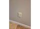 A close-up shot of a central vacuum cleaner wall socket in a room with beige walls at 9729 Asbel Estates St, Land O Lakes, FL 34638