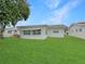 Spacious backyard features a well-maintained lawn and patio area perfect for relaxation at 9737 36Th N Way, Pinellas Park, FL 33782