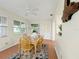 Bright dining area featuring a wood table, ceiling fan, and views of the outdoors through large windows at 9737 36Th N Way, Pinellas Park, FL 33782