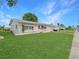 Beautiful single-story home with green lawn, colorful red awnings, and an attached garage on a sunny day at 9737 36Th N Way, Pinellas Park, FL 33782