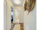 Hallway with neutral walls leading to a bathroom and bedroom, decorated with stylish wall art at 9737 36Th N Way, Pinellas Park, FL 33782