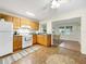Bright kitchen with wood cabinets, white appliances, and seamlessly connected dining space at 9737 36Th N Way, Pinellas Park, FL 33782