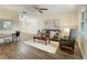Comfortable living room featuring wood flooring, neutral paint, and a decorative ceiling fan at 9737 36Th N Way, Pinellas Park, FL 33782