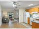 Living room view into kitchen. The rooms are divided by floor type, appliances viewable in kitchen at 9737 36Th N Way, Pinellas Park, FL 33782
