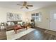 Bright living room with hardwood floors, neutral paint, a ceiling fan, and comfortable furnishings at 9737 36Th N Way, Pinellas Park, FL 33782