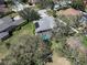 An aerial view of a beautiful property with a screened-in pool, lush landscaping, and mature trees at 10129 Paddock Oaks Dr, Riverview, FL 33569