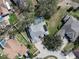 An aerial view of a well maintained property featuring a screened pool, solar panels, and beautiful landscaping at 10129 Paddock Oaks Dr, Riverview, FL 33569
