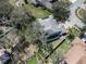 An aerial shot of a beautiful home featuring a screened-in pool, solar panels, and a large backyard at 10129 Paddock Oaks Dr, Riverview, FL 33569