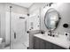 Bathroom features a large glass shower, decorative tile, and a round mirror at 10129 Paddock Oaks Dr, Riverview, FL 33569