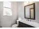 Half bath with a modern vanity, toilet, and a window for natural light at 10129 Paddock Oaks Dr, Riverview, FL 33569