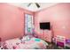 Pink themed bedroom with character bedding and a ceiling fan at 10129 Paddock Oaks Dr, Riverview, FL 33569